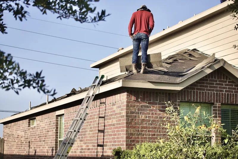 Professional roofer working on a residential roof in Lane